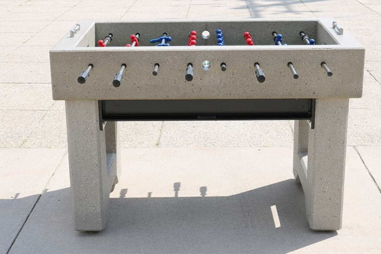 Concrete foosball table showing its solid base and outdoor playing surface