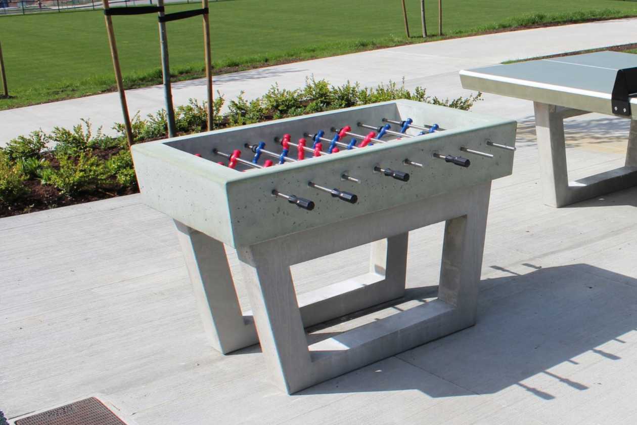 Concrete foosball and ping pong tables in an outdoor recreation area